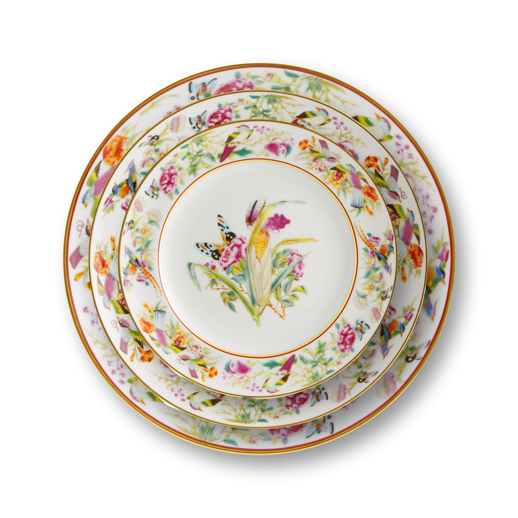 Platos de la Colección Paço Real de Vista Alegre con borde rosa y motivos de frutas y flores en oro.