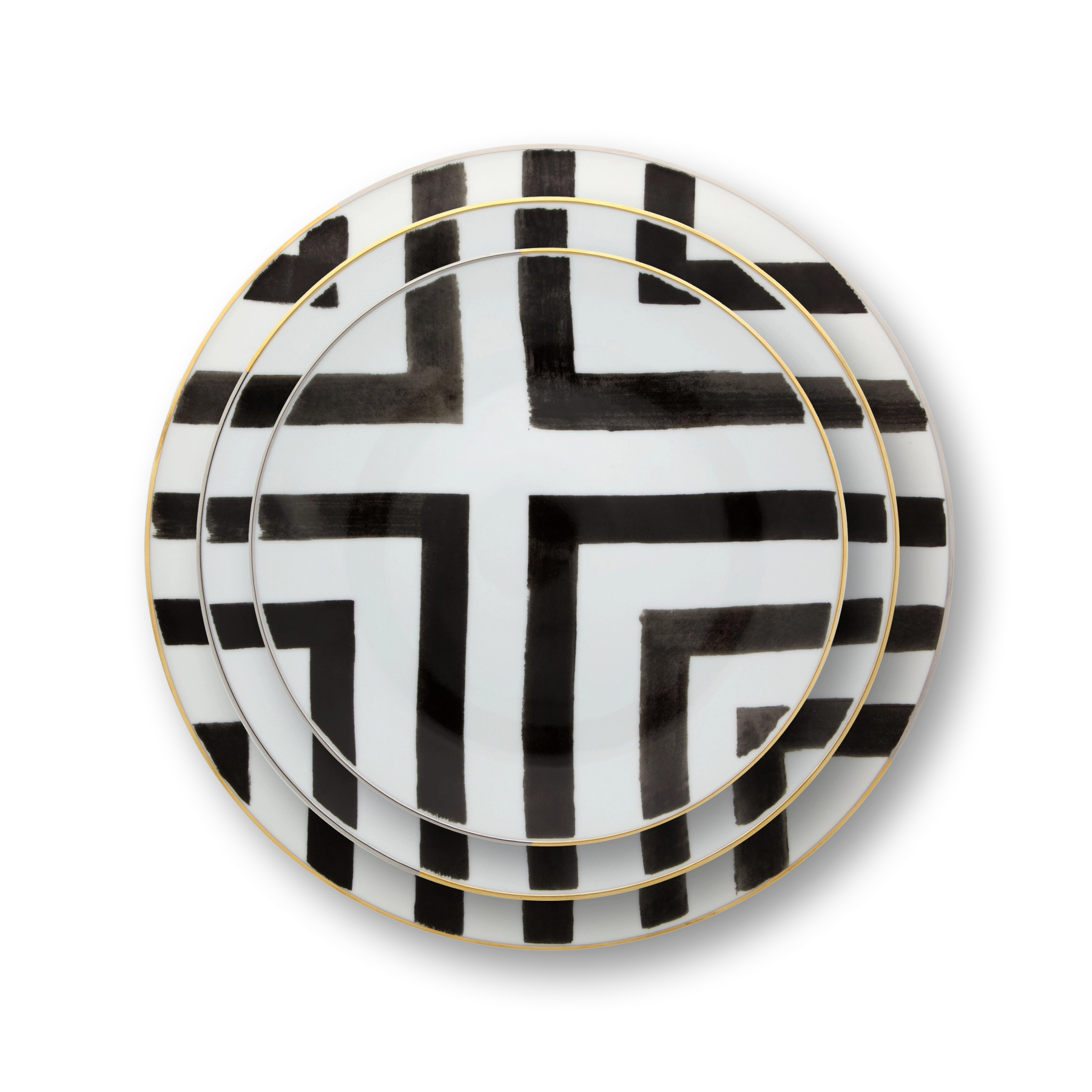 Platos de puesto de la Colección Sol & Sombra de Vista Alegre, resaltando el diseño de acuarela en forma de cruz con borde de oro.