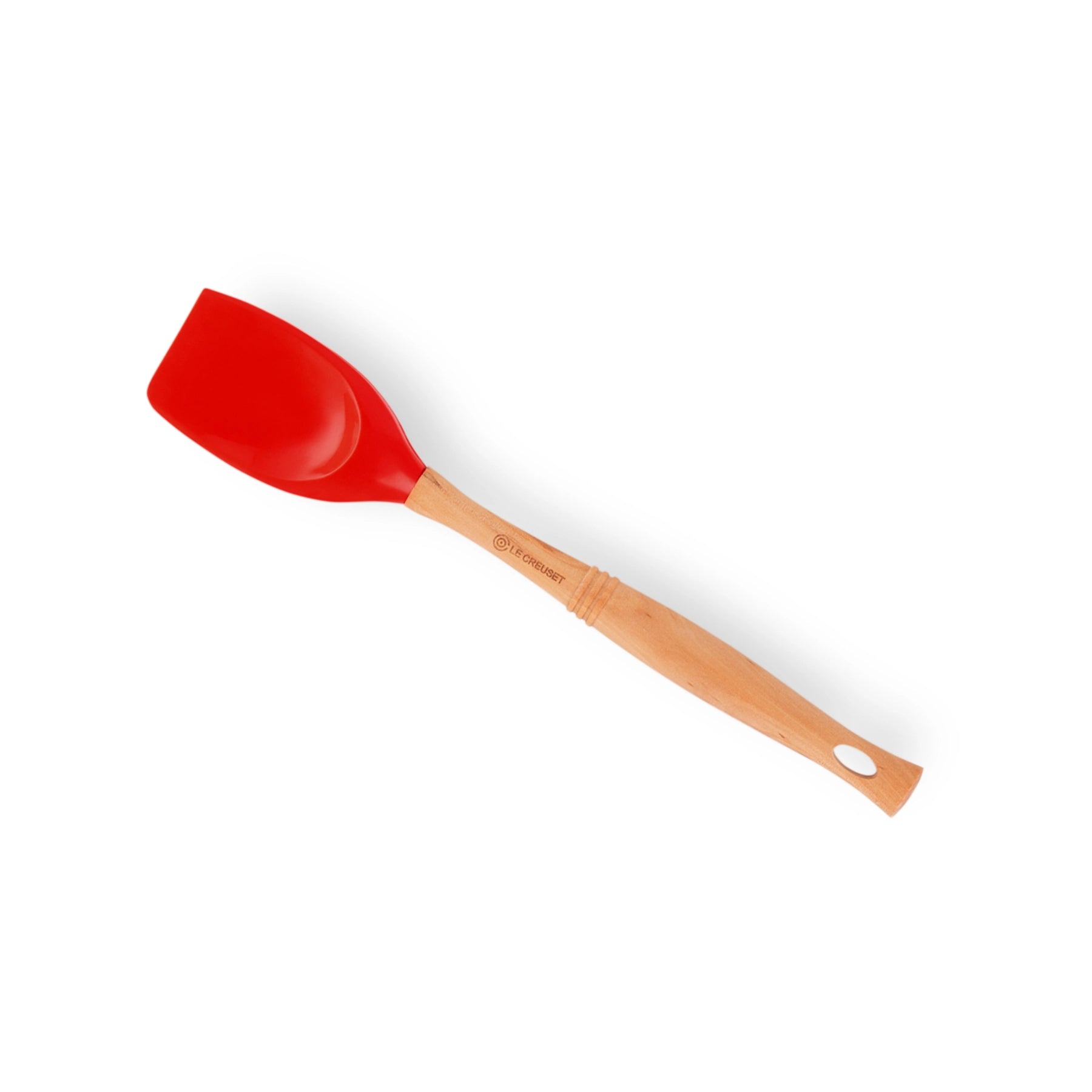 Espátula Pro Cereza de Le Creuset, mostrando su cabezal de silicona roja brillante y su clásico mango de madera.