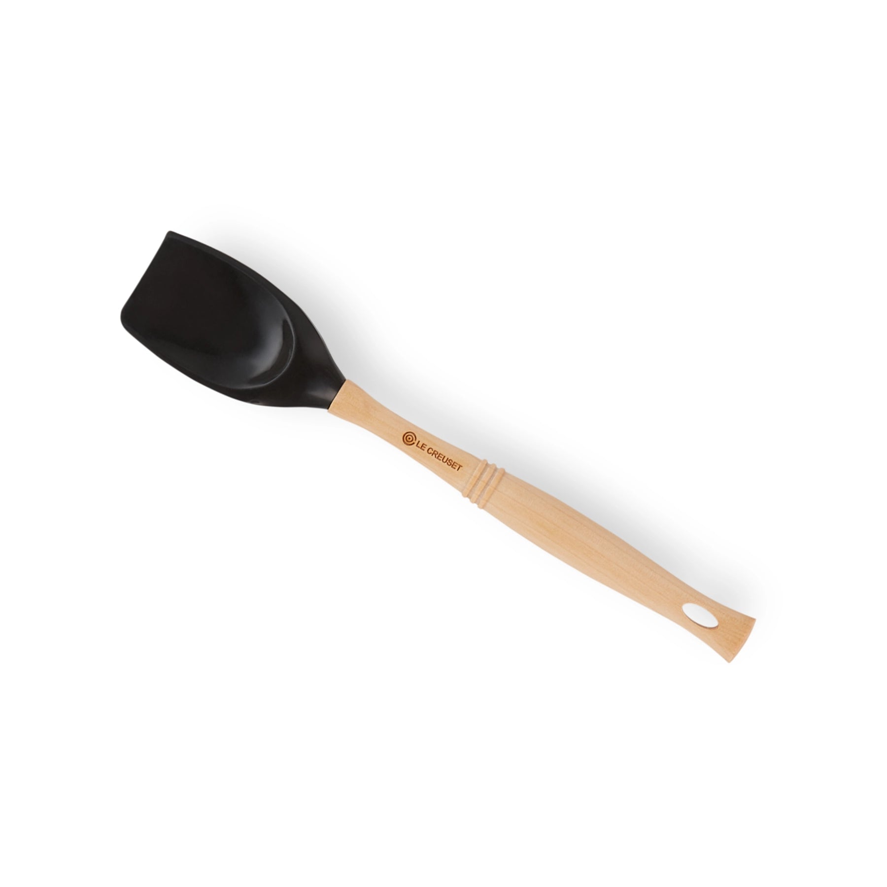 Espátula Pro Negro de Le Creuset, mostrando su cabezal de silicona negro brillante y su clásico mango de madera.