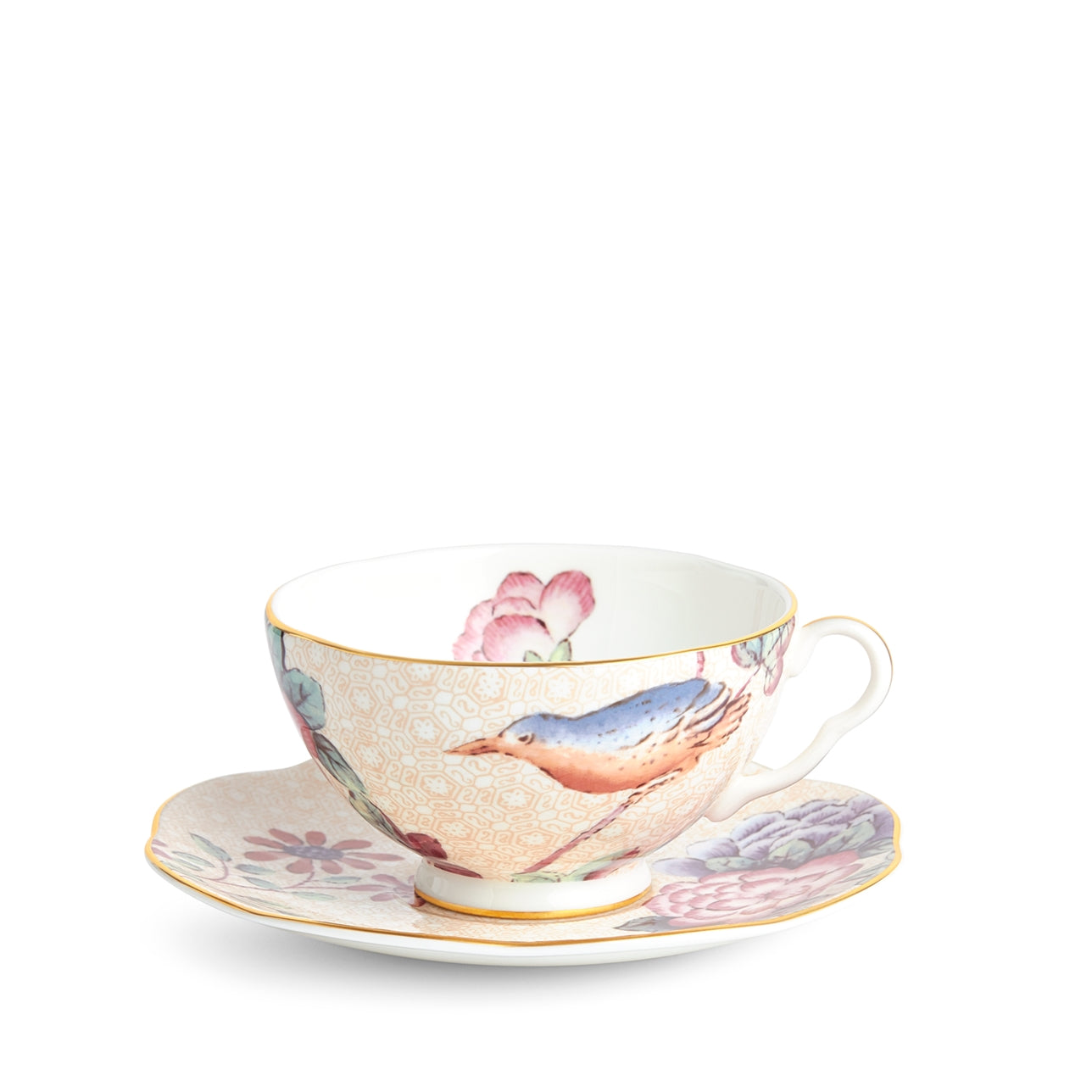 Juego de plato y taza de té Durazno Cuckoo con detalles dorados.