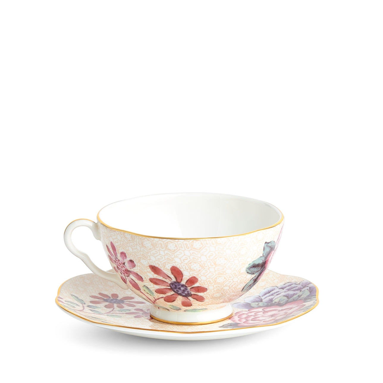 Juego de plato y taza de té Durazno Cuckoo con detalles dorados.