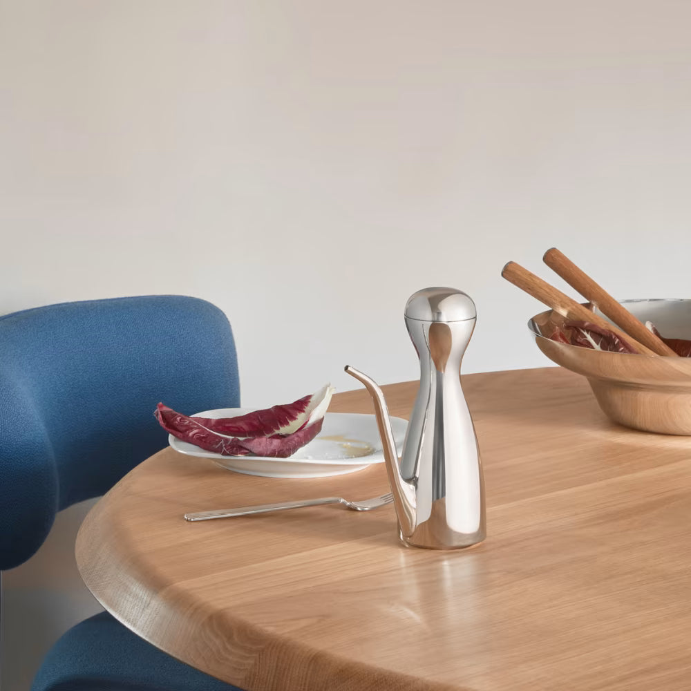 Aceitera Alfredo de Georg Jensen, mostrando el diseño curvo y pulido con aceite de oliva.
