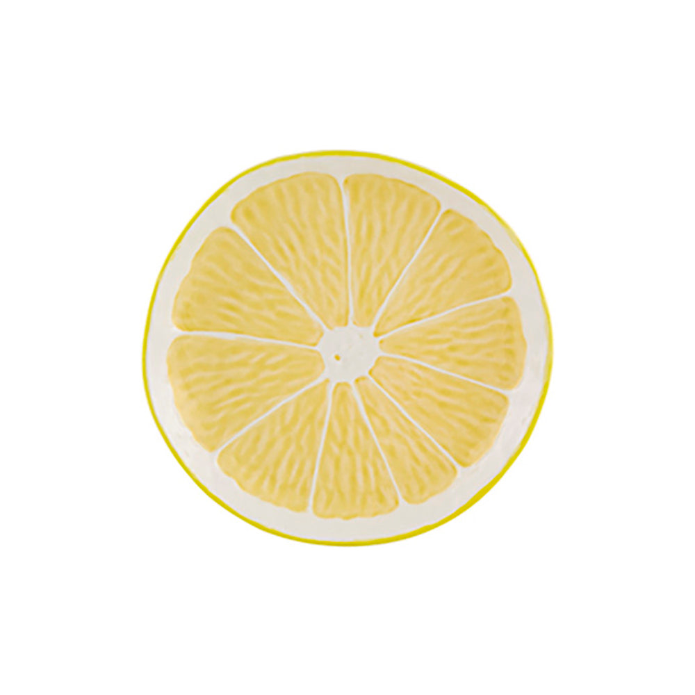 Plato de Fruta Limón de Bordallo Pinheiro, mostrando su superficie amarilla con textura de piel de cítrico y hojas verdes.